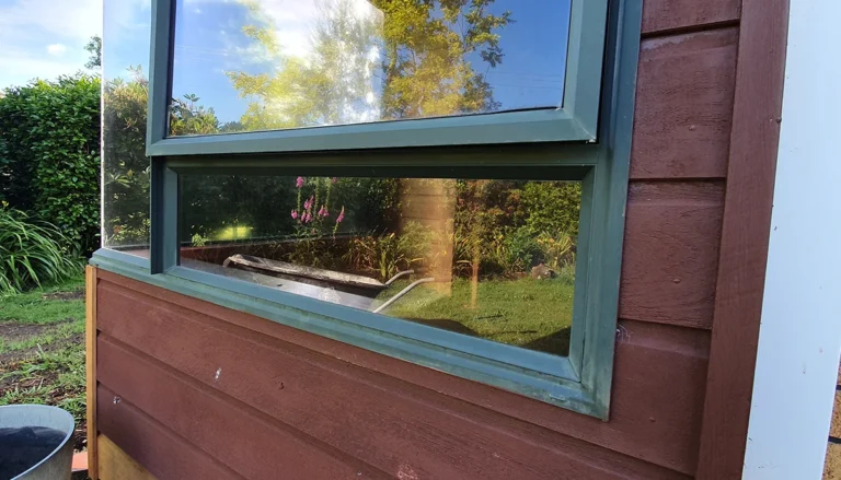 Green aluminium window frame showing its original weathered finish before Nano-Clear recolouring from green to black for a modern, refreshed appearance.