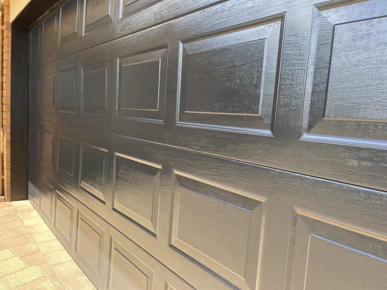 Garage door after Nano-Clear rejuvenation with restored colour and finish